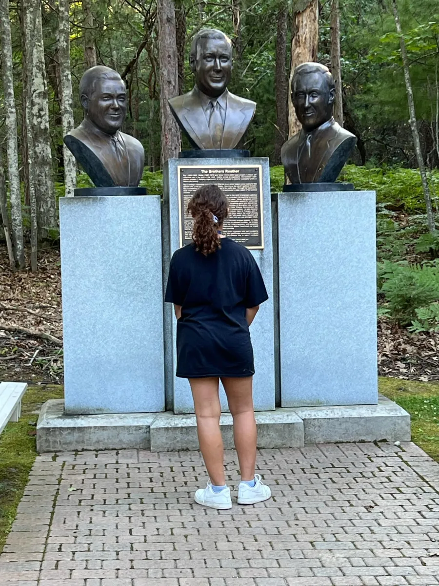 Family member at UAW Family Scholarship looking at the Reuther brothers' statues